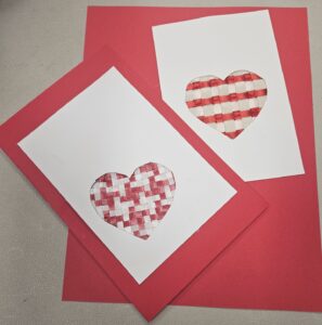 Red and white card with Heart cutout and ribbon weaving in the cutout